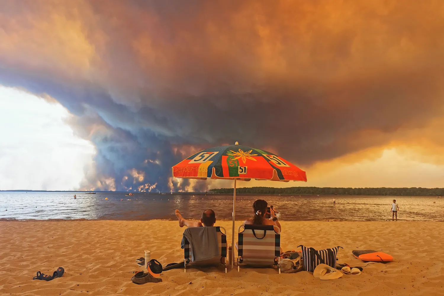 Beachgoers rest on the beach of Moutchic on the shore of Lake Lacanau. (Maximilien Lamy/AFP via Getty Images)